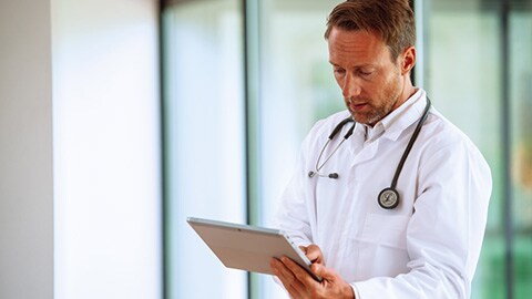 Physician looking at tablet